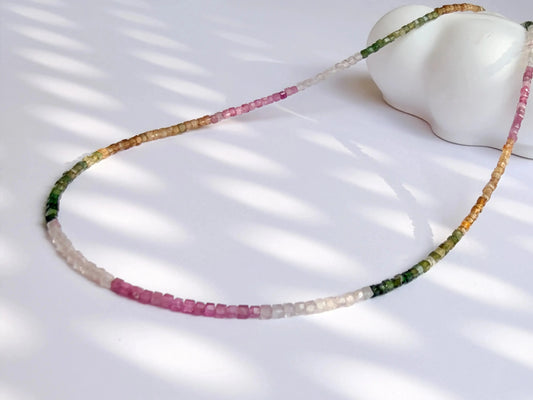 Necklace with multicolored tourmaline beads on a white surface