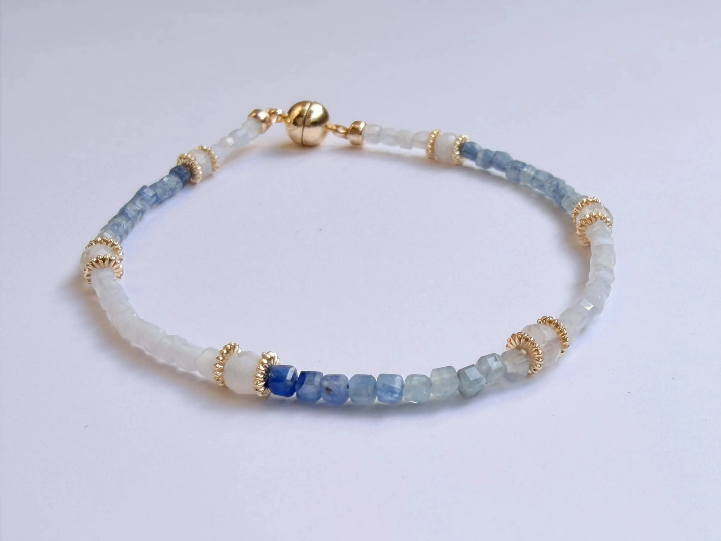 Japanese Minimalist bracelet with blue kyanite and white moonstone beads on a light gray background