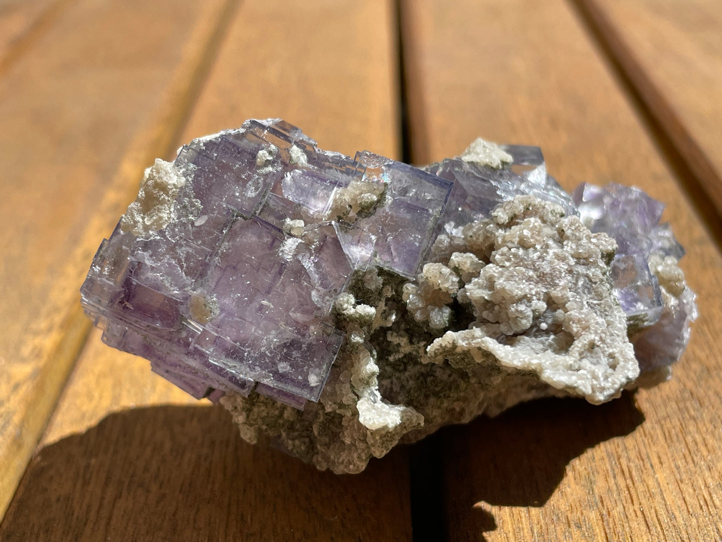 Yaogangxian purple fluorite top view — jewel-toned cubic crystal with transparent edges, 78mm cabinet specimen