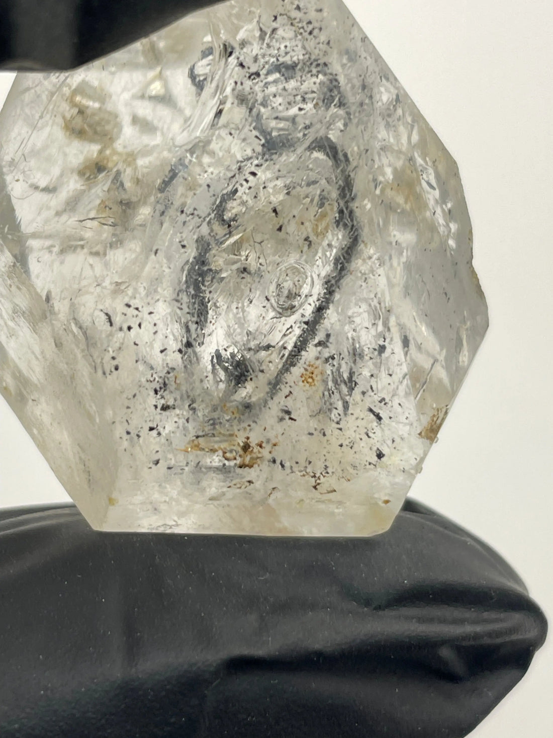 a hand-held white clear quartz with bubble moving inside the crystal
