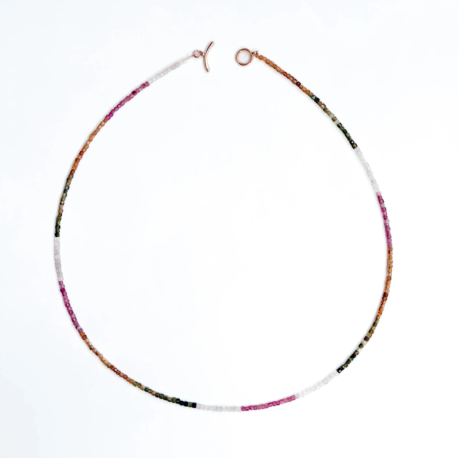 Rainbow tourmaline beaded necklace - pink, yellow, white, green gradient colors on white background
