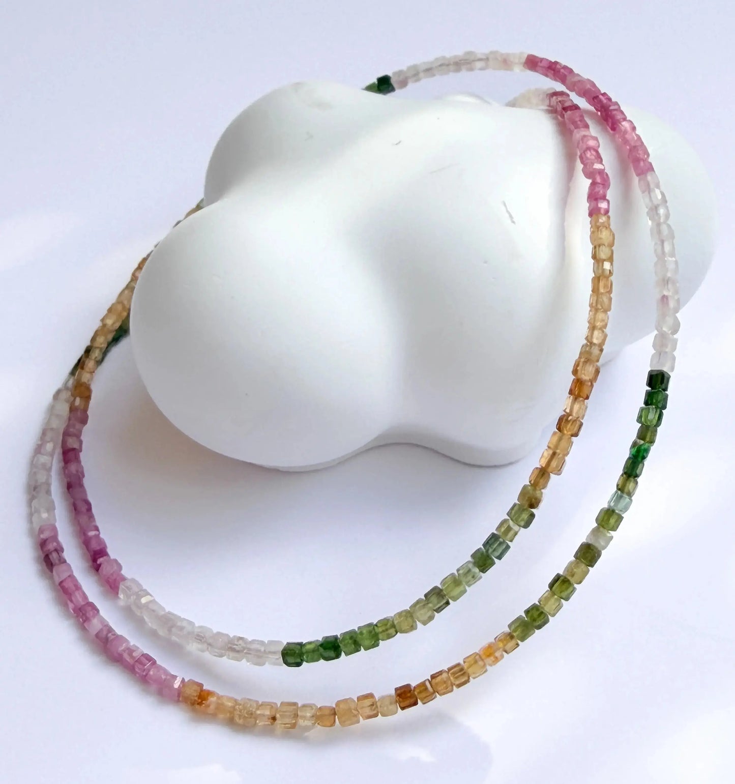 Multicolored beaded necklace on a white mannequin bust