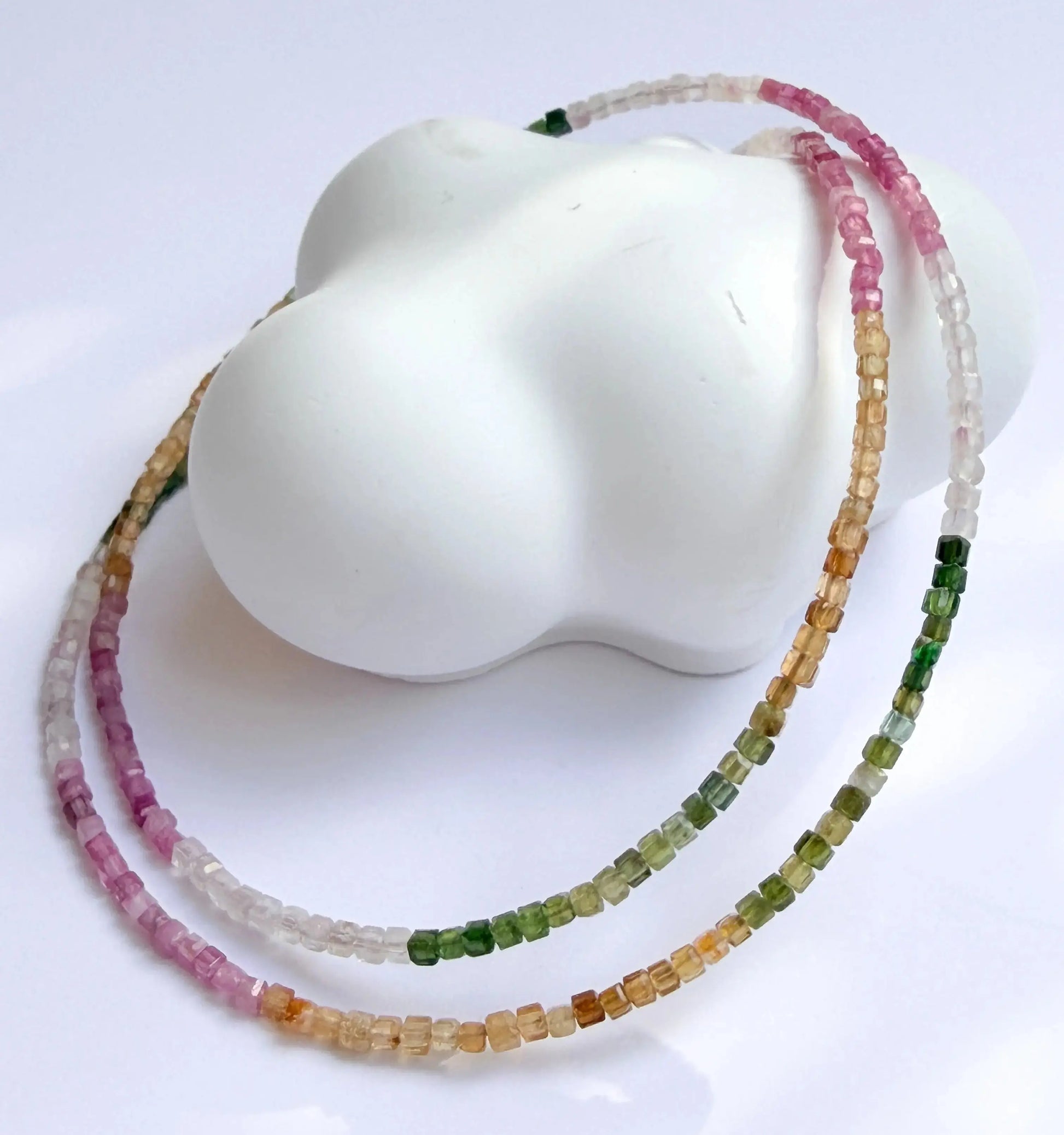 Multicolored beaded necklace on a white mannequin bust