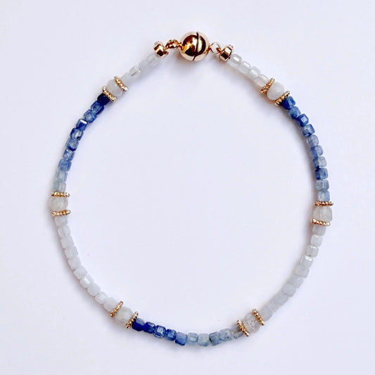 Japanese Minimalist bracelet with blue kyanite and white moonstone beads on a light gray background