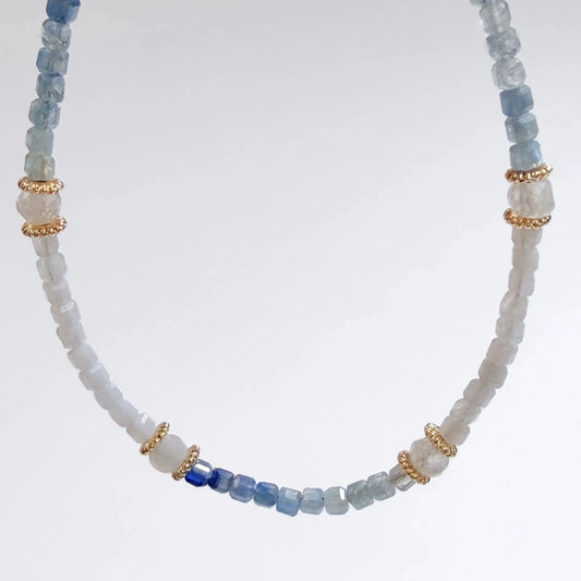 Japanese Minimalist bracelet with blue kyanite and white moonstone beads on a light gray background