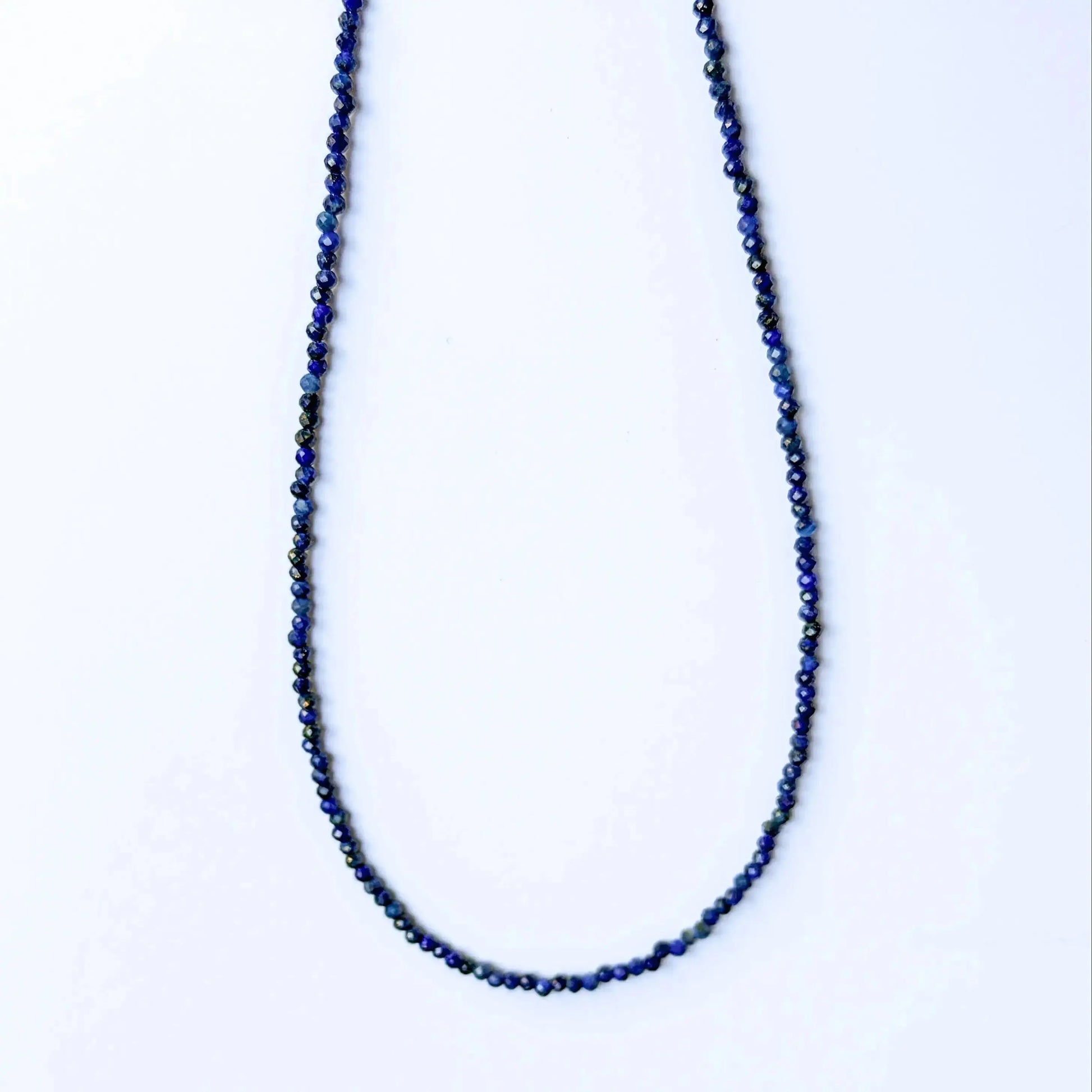 Lapis Lazuli jewelry - Necklace with blue beads on a white background