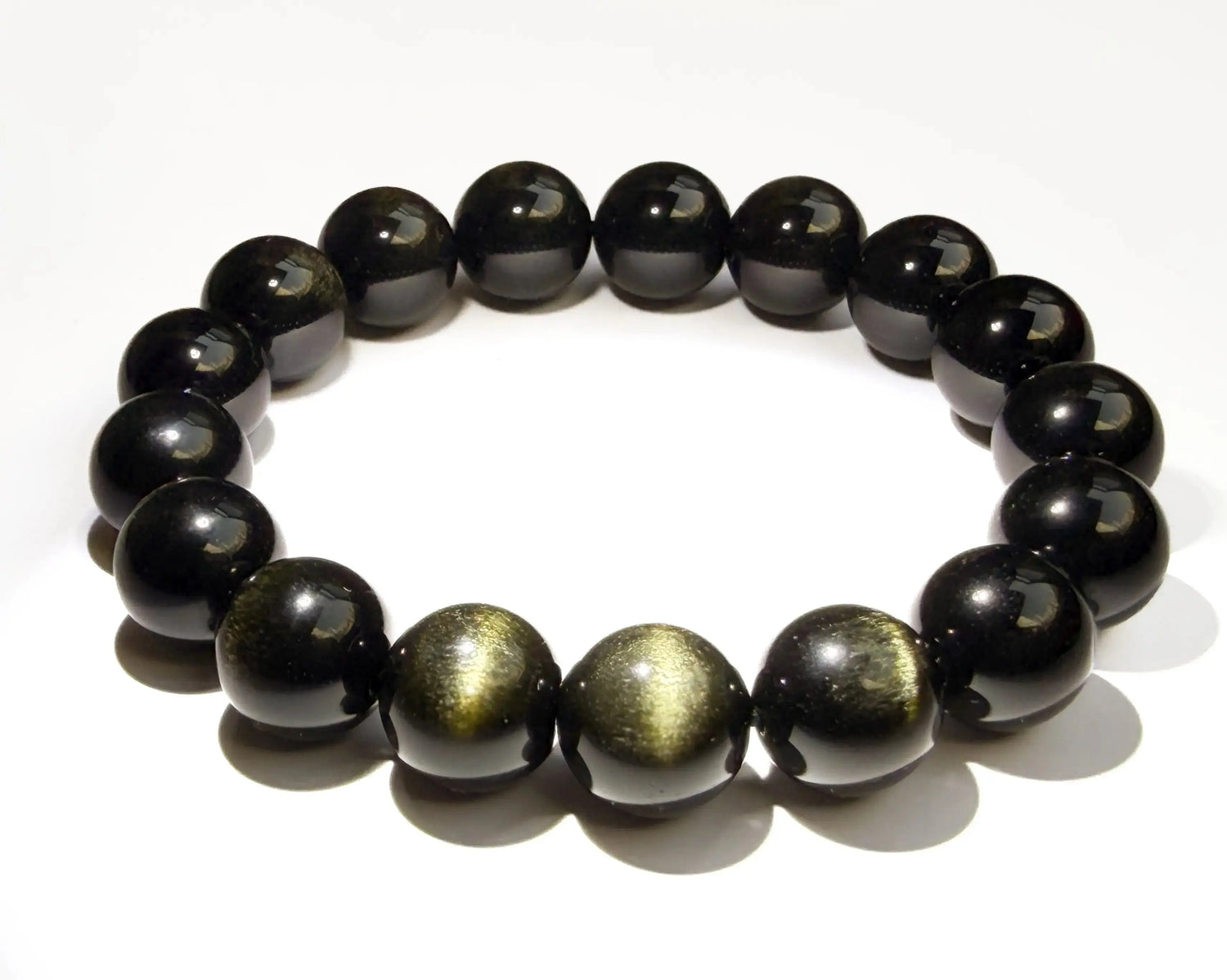 Gold sheen obsidian bracelet on white desk