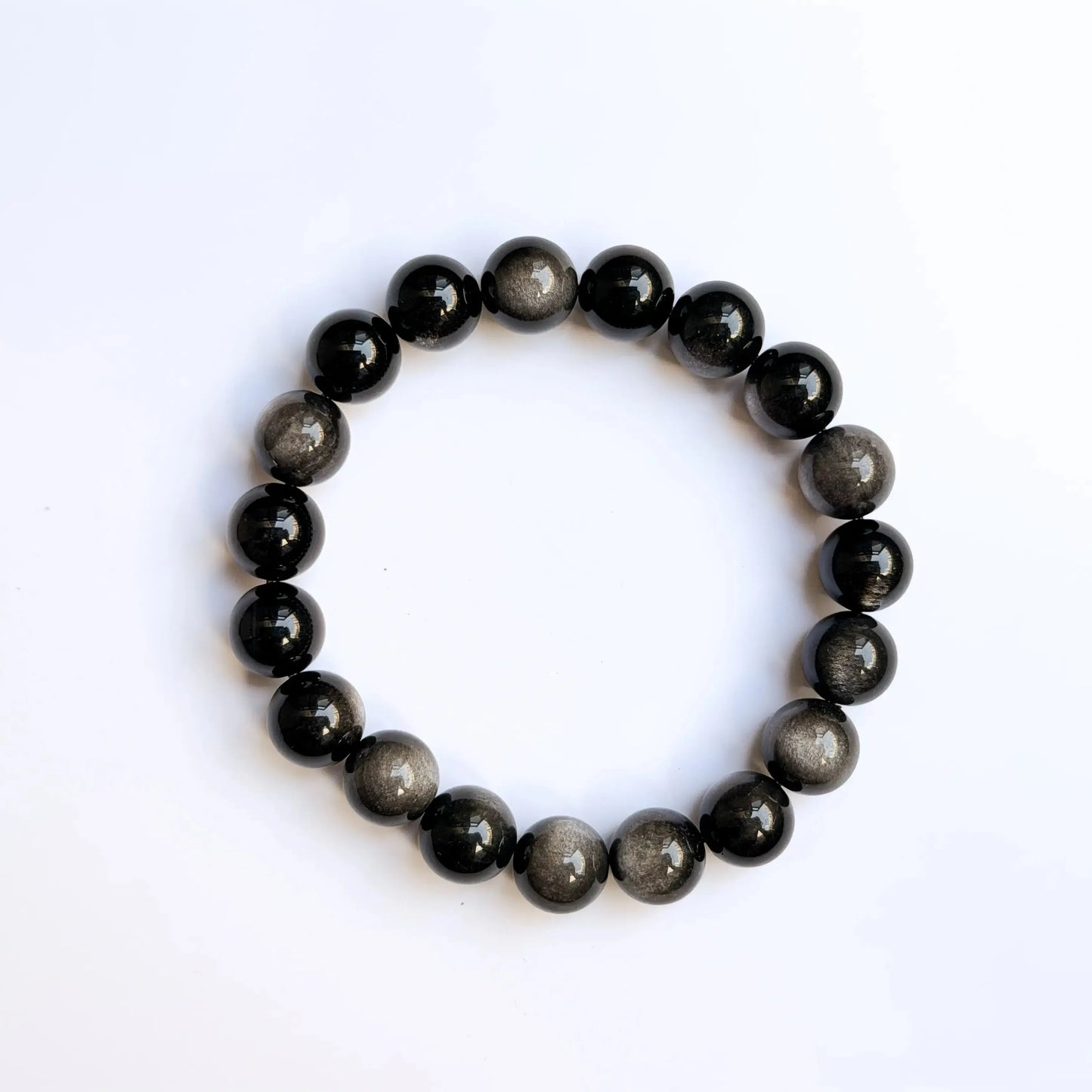 silver sheen obsidian bracelet on white desk
