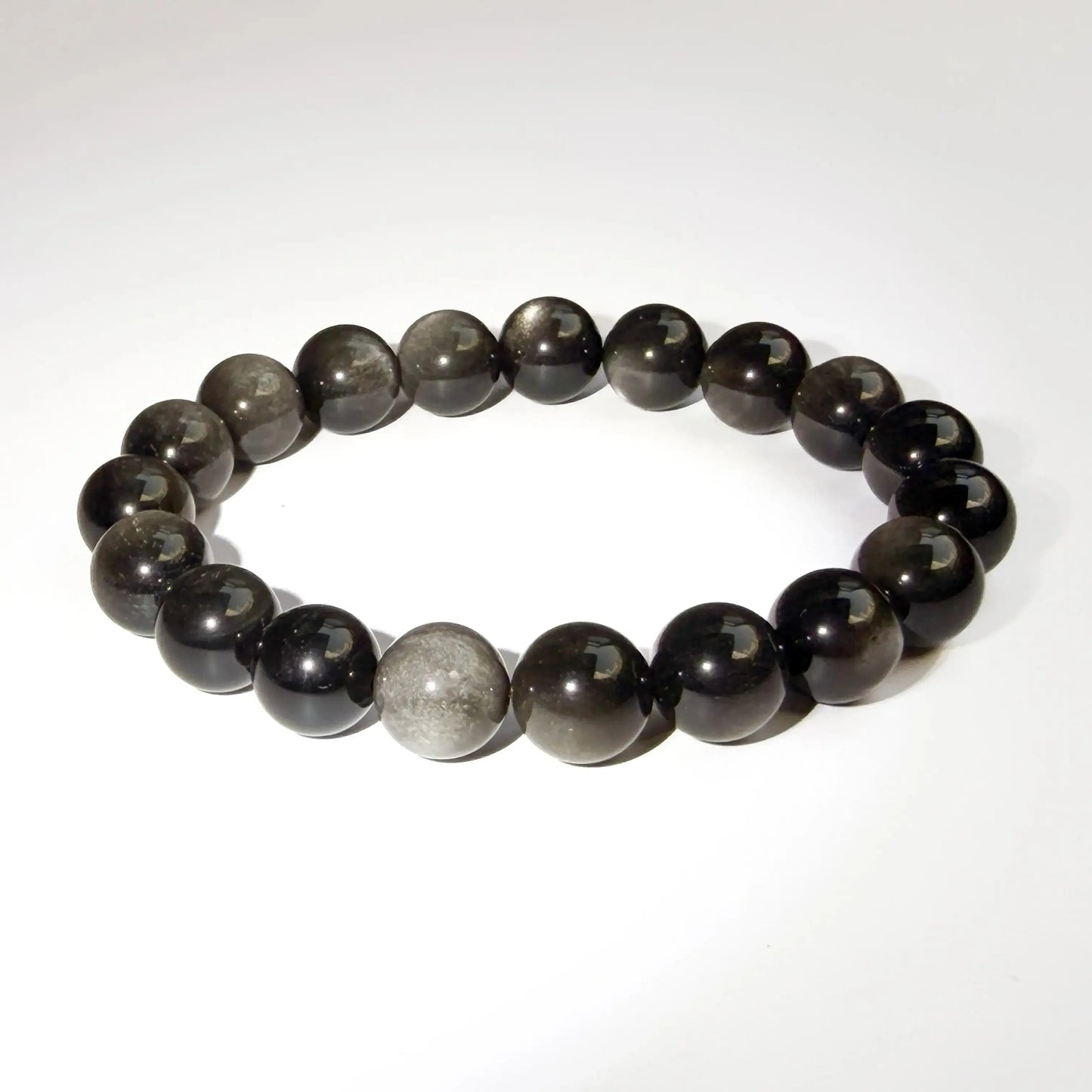 silver sheen obsidian bracelet on white desk