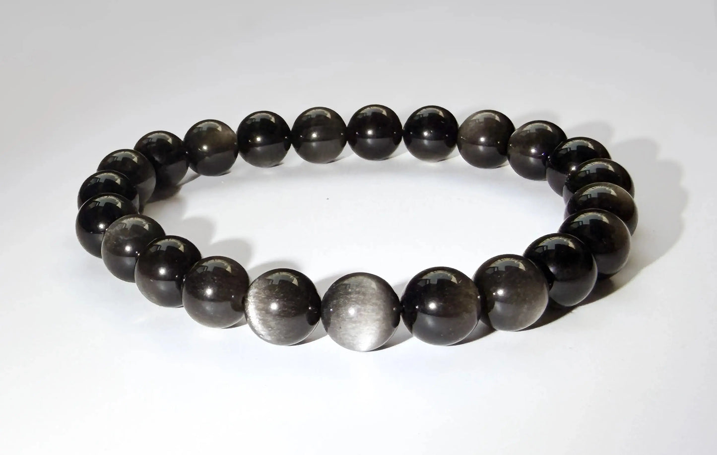 silver sheen obsidian bracelet on white desk
