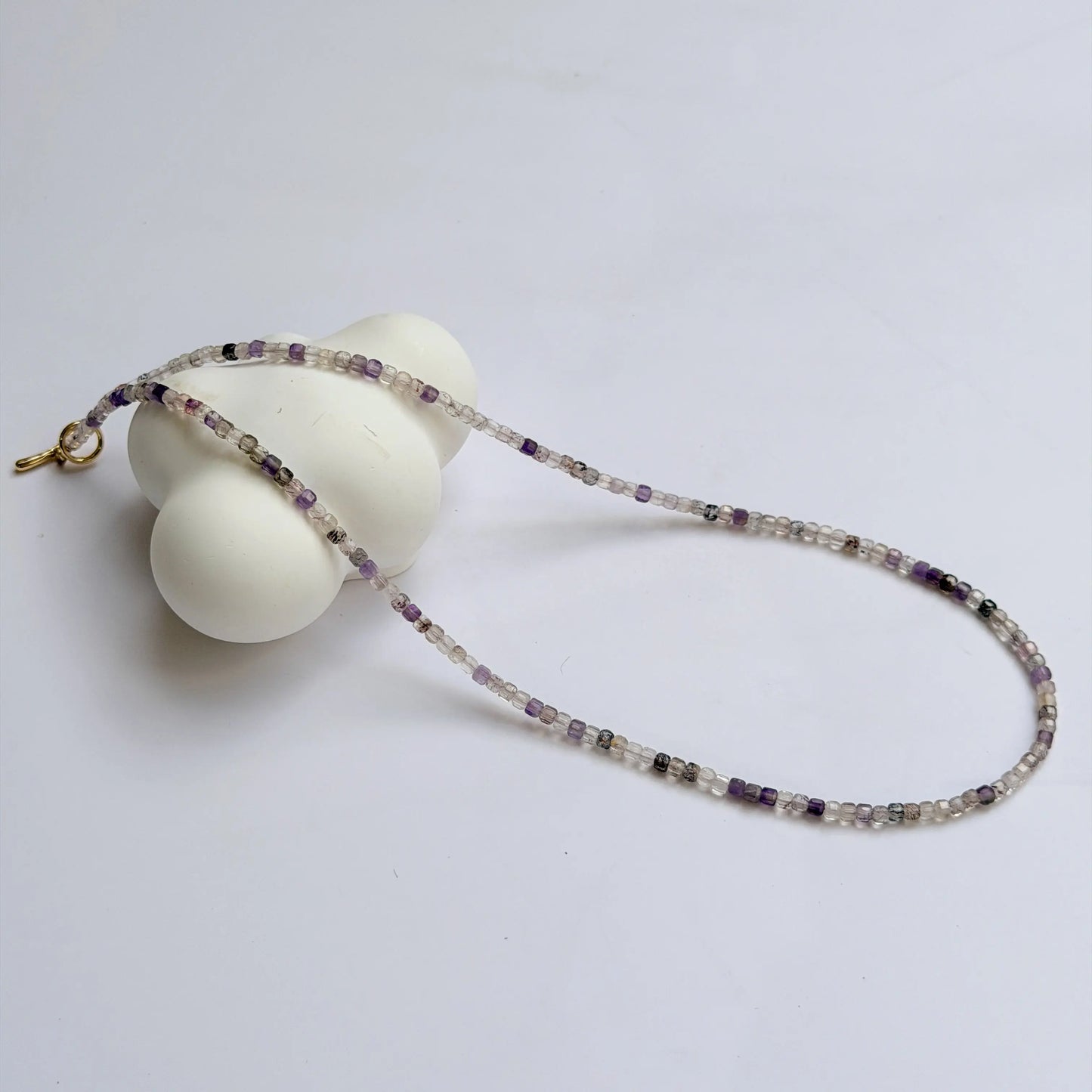 Super 7 Amethyst Necklace with small beads on a white background