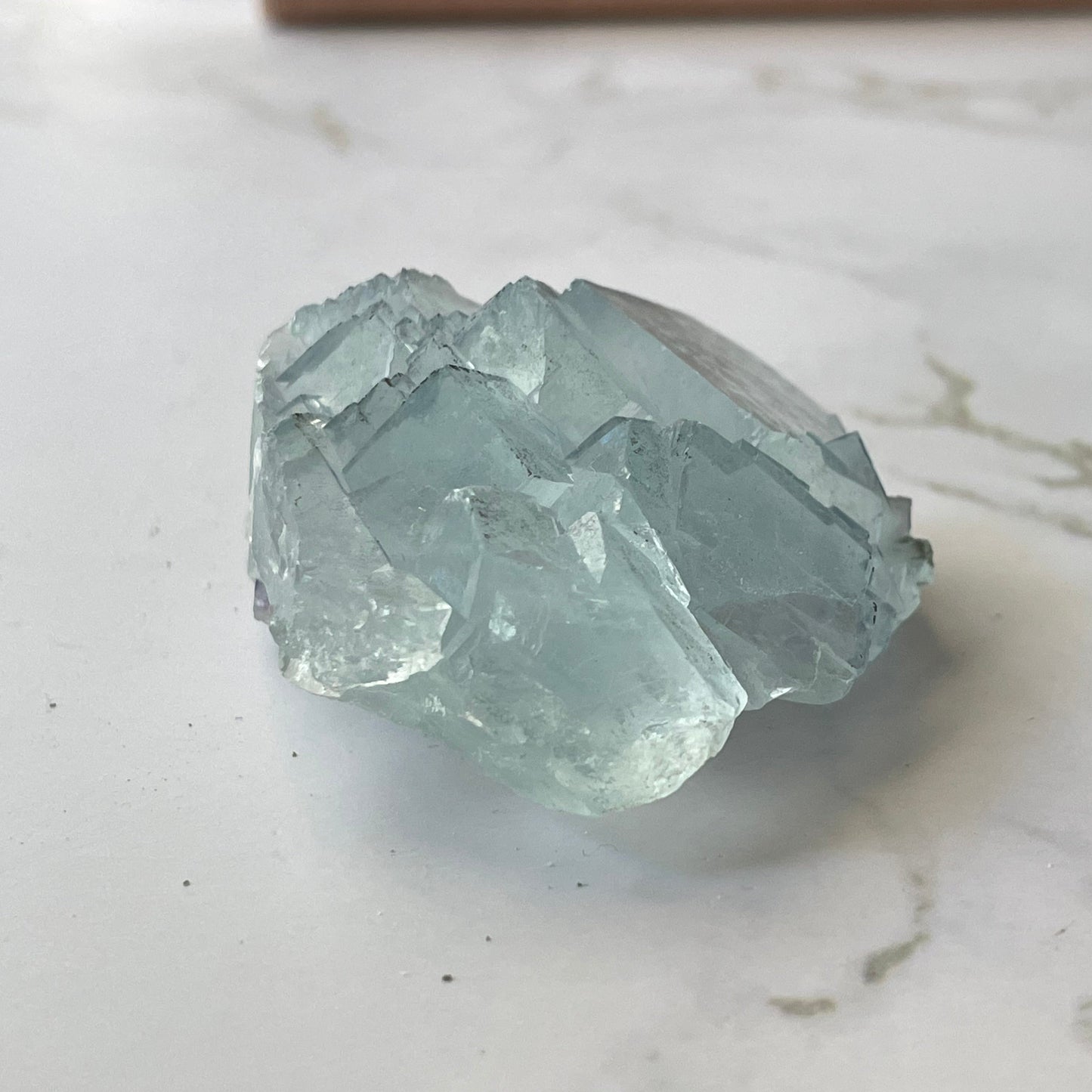 Baby blue Yaogangxian fluorite angled view — sharp cubic terminations, glassy luster, 60mm cabinet specimen