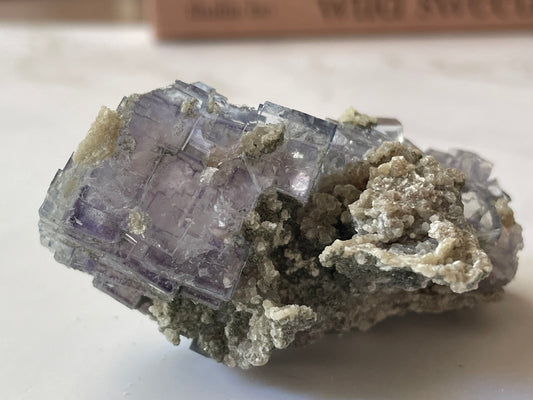 Deep violet Yaogangxian fluorite specimen angled view — sharp cubic crystal terminations and glassy luster