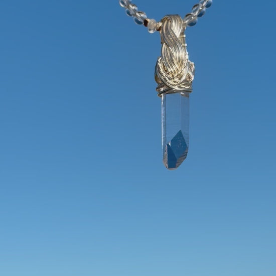 Himalayan Quartz Point Handwired Necklace on a blue sky background