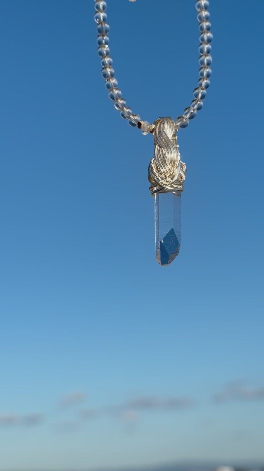 Himalayan Quartz Point Handwired Necklace on a blue sky background