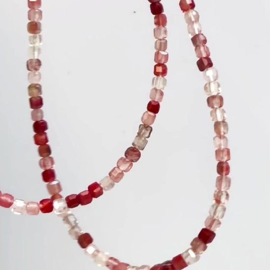 Andesine Japanese Minimalist Gemstone Jewelry with sparkly red color in motion